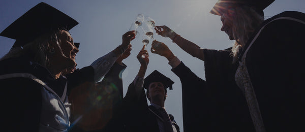 Australian graduates celebrating in their grad attire 