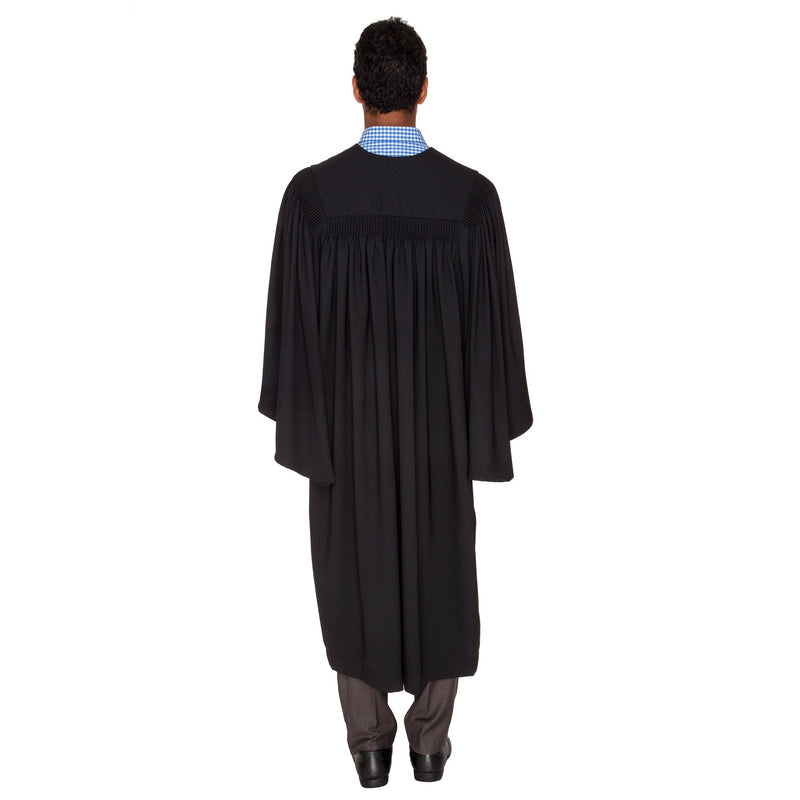 man wearing a black bachelor graduation gown, back view
