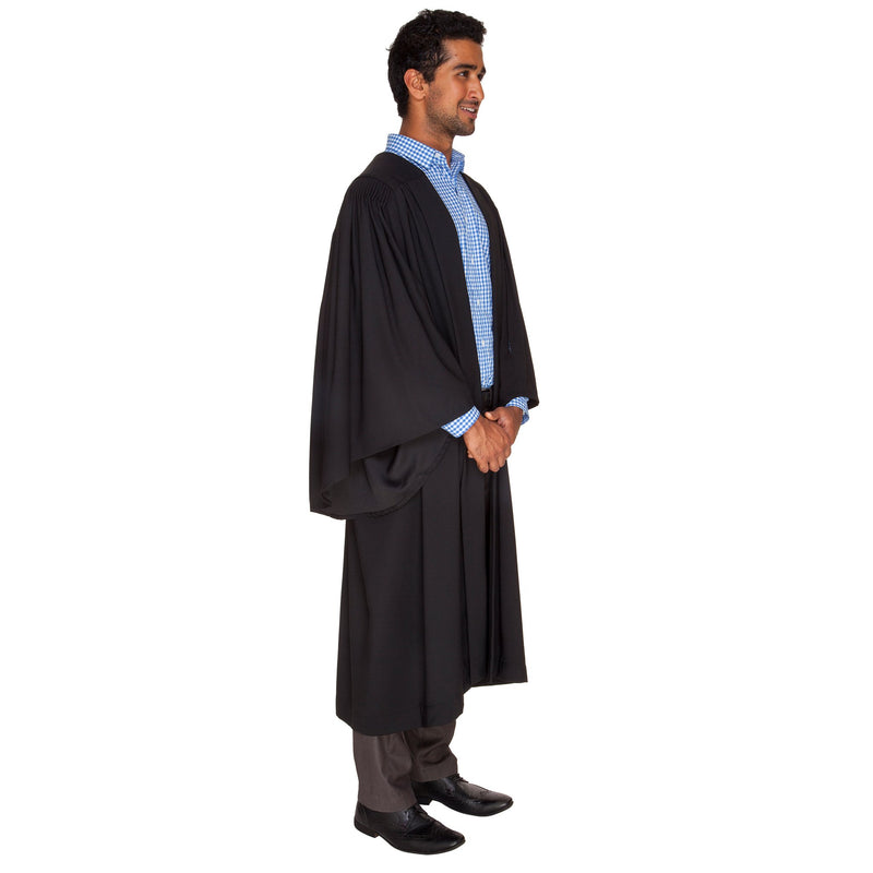 Side view of a man wearing a bachelor graduation gown