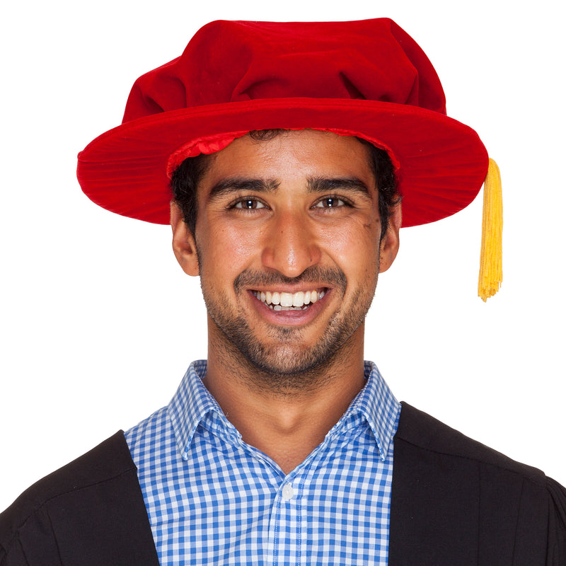 Red velvet PhD hat (bonnet) with gold cord (tassel)