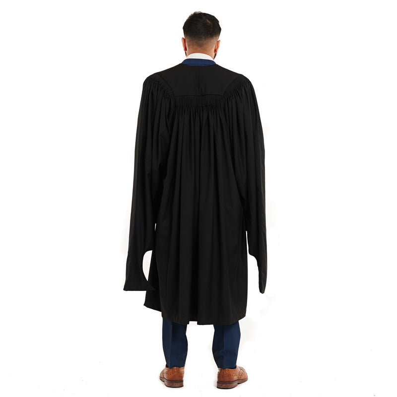 Back view of a man wearing a Master's graduation gown