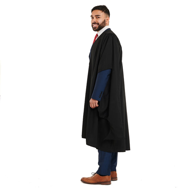 Side view of a man wearing a master's graduation gown