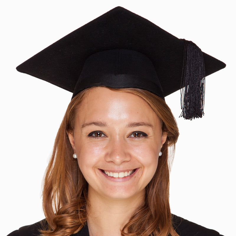 Smiling woman wearing a black felt mortarboard cap