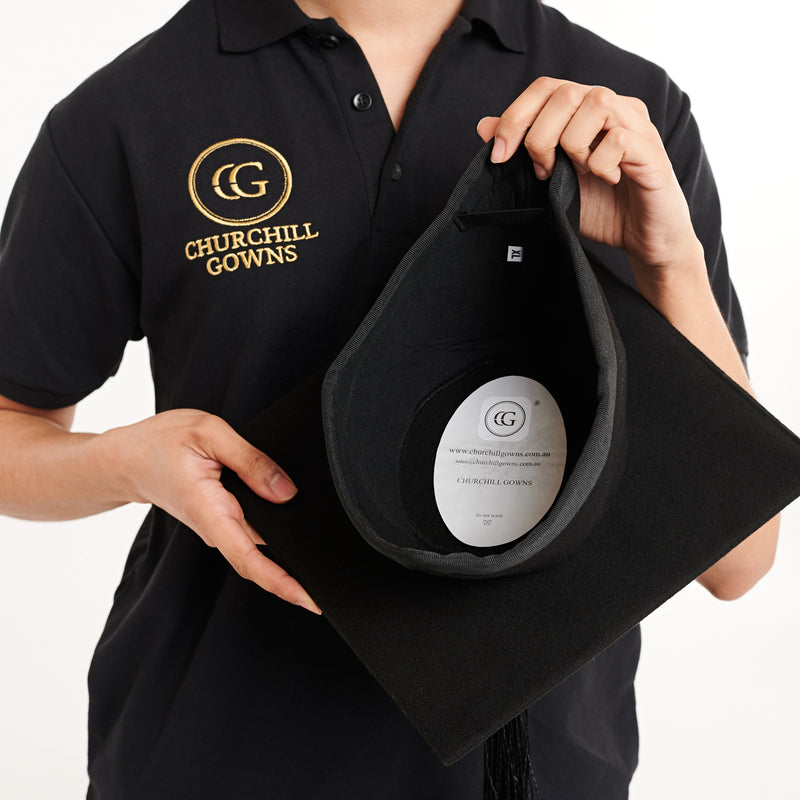 Woman holding a Churchill Gowns mortarboard cap