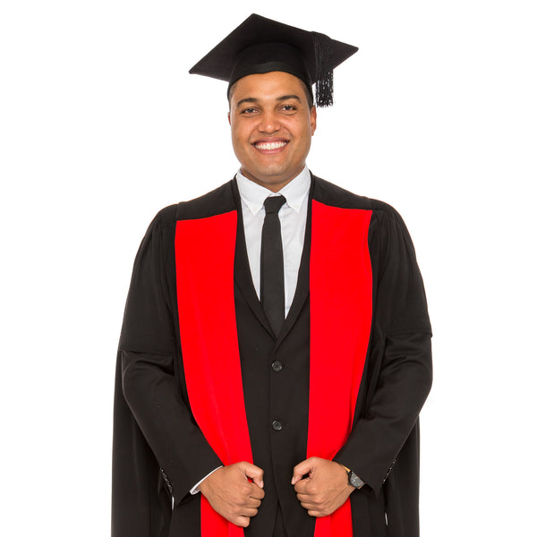 Man wearing a PhD gown with red facings and a graduation hat
