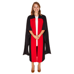 Woman wearing a black PhD gown with red facings