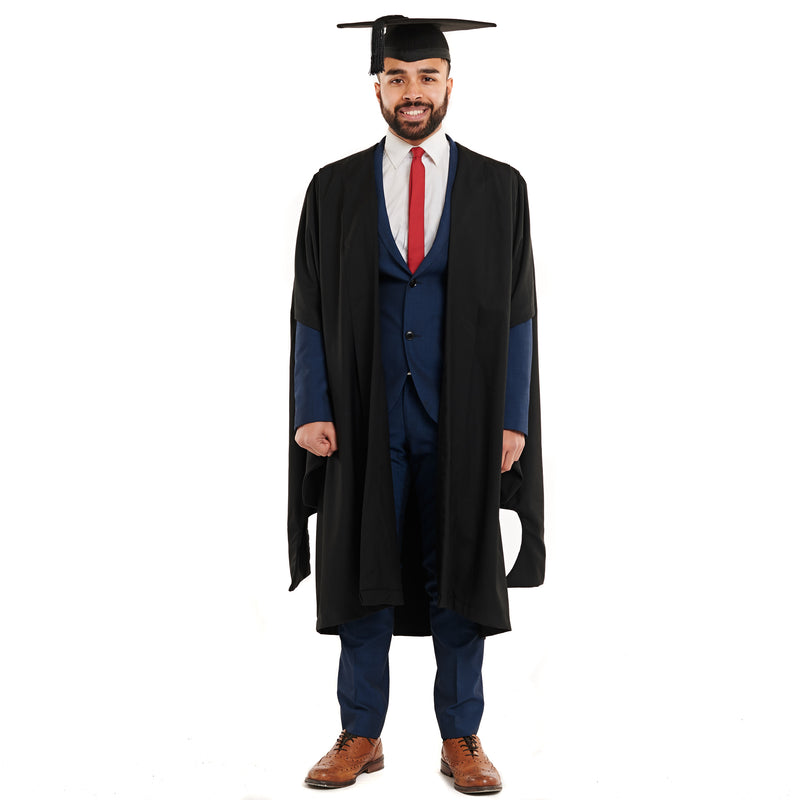 Man wearing a masters graduation gown and graduation hat